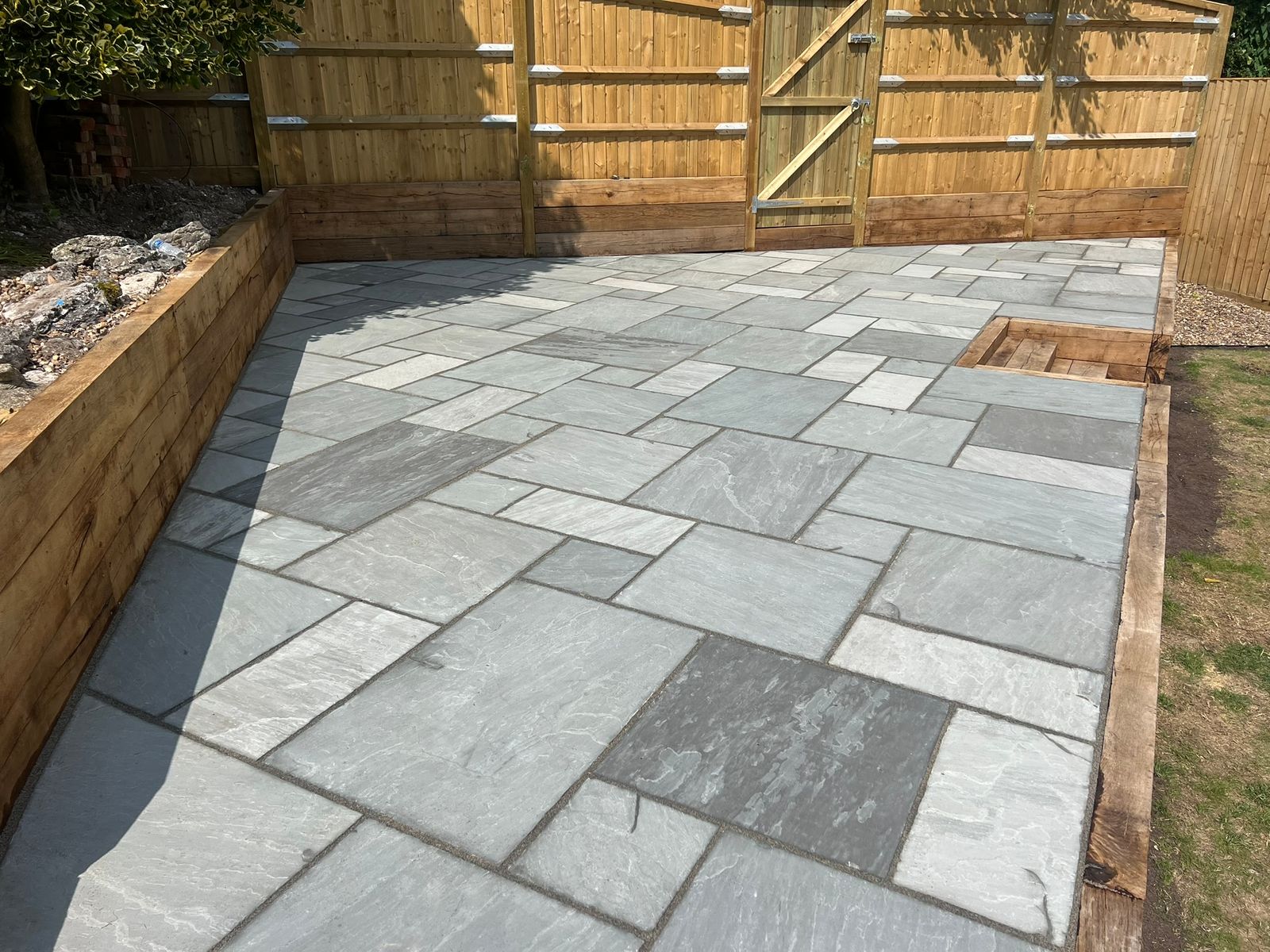 Sandstone Patio With sleeper retaining wall - view 2