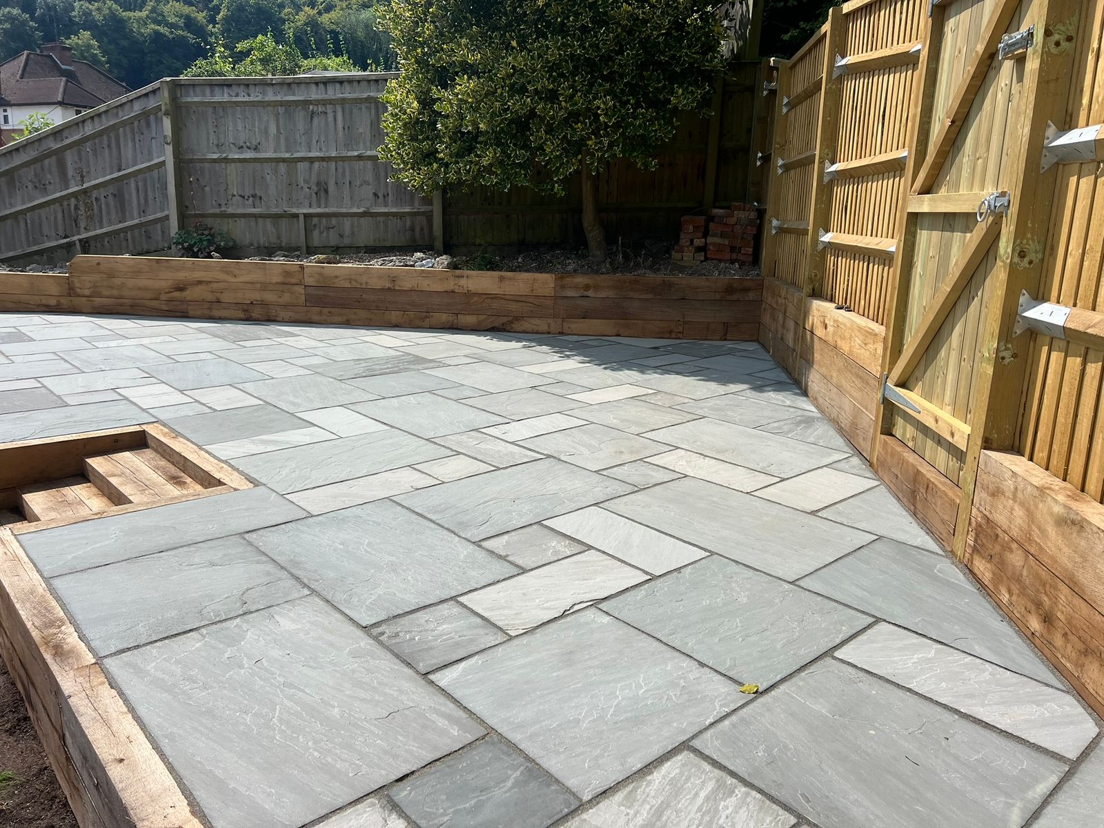 Sandstone Patio With sleeper retaining wall - view 5