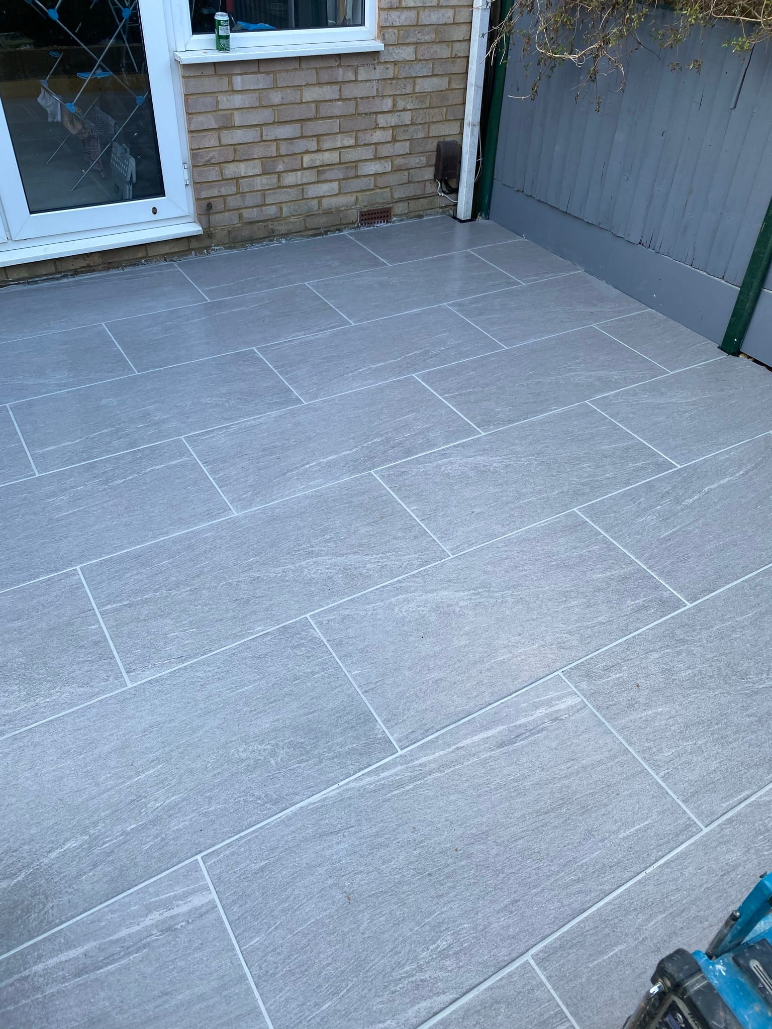 Patio with Sleeper Wall - Porcelain patio installation in Bovingdon, HP3